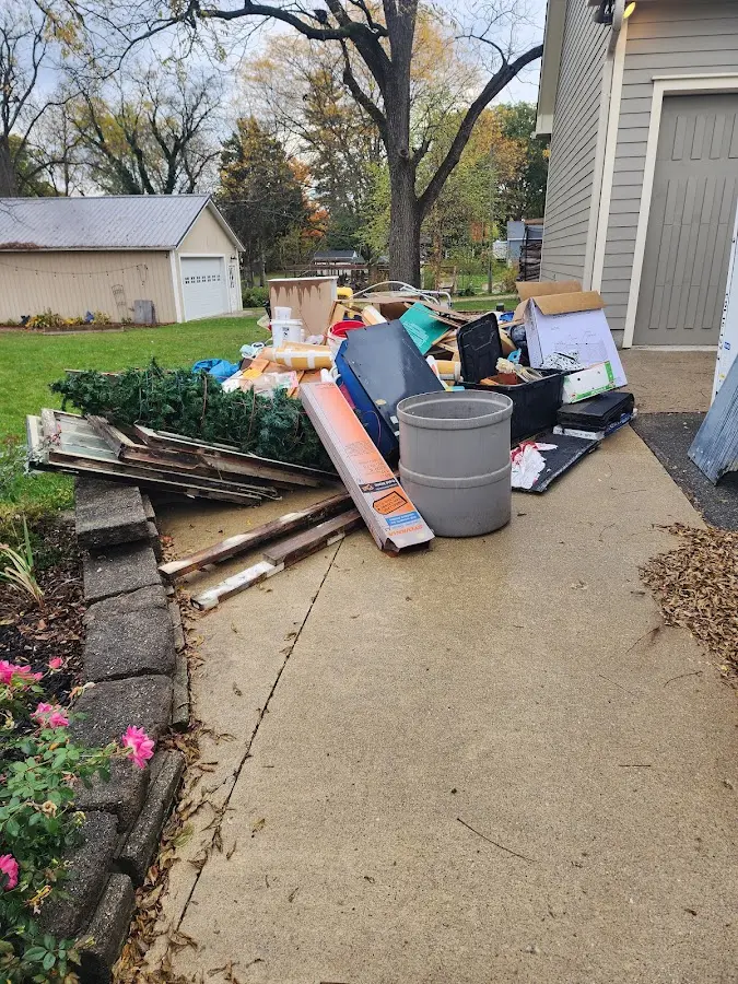 Dumpster being loaded with debris for Estate Cleanout Dumpster Rental in Saratoga Springs